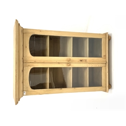 Victorian pine bookcase, projecting cornice over two arched glazed doors enclosing three adjustable shelves, raised on bun supports 