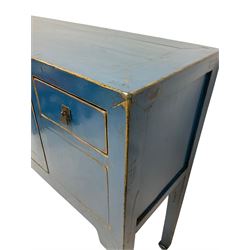 Chinese blue side cabinet, the rectangular top over two cupboard doors and two drawers, raised on squared supports 