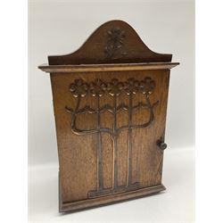 Art Nouveau oak wall cabinet, the hinged door and pediment applied with stylized copper flowers, H43cm x W29.5cm