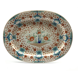 Early 19th century oval meat plate painted with Japanese flowers in orange and blue W52cm