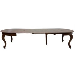Large 20th century mahogany extending dining table, circular moulded top with seven additional leaves, raised on acanthus carved cabriole supports with scrolled terminals, on brass castors
