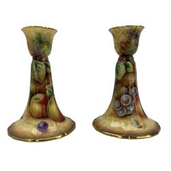 Pair of Royal Worcester candlesticks painted with still life of peaches, grapes etc on a mossy bank by P Stanley H12cm