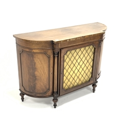 Regency style mahogany break bow front chiffonier side cabinet, rosewood cross banded top over boxwood stringing to frieze, brass grill and silk curtain to centre door, enclosed by turned pilasters and two panelled cupboards, raised on turned supports, W122cm, H85cm, D40cm