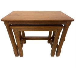 Rabbitman - oak nest of two tables with with rectangular tops, raised on octagonal supports united by plain stretchers, each carved with rabbit signature, by Peter Heap, Wetwang