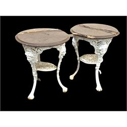 Pair of Victorian style white painted cast iron pub tables, circular hardwood tops raised on three splayed supports with mask decoration united by under tier D60m, H70cm