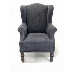 Early 20th century wing back armchair, upholstered in navy blue fabric, raised on turned and reeded front supports W69cm