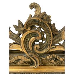 19th century giltwood and gesso wall mirror, the rectangular frame with c-scroll and torch pediment, moulded scrolling flower head and foliage decoration, foliage moulded corner brackets