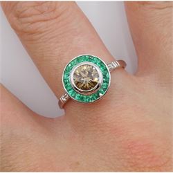 18ct white gold calibre cut emerald and fancy champagne colour diamond target ring, with diamond set shoulders, stamped 18K, total emerald weight approx 0.45 carat, central diamond approx 0.80 carat

