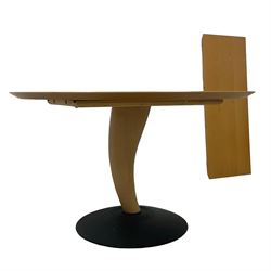 Contemporary light beech extending dining table, circular pull-out action top with additional leaf, on sculptural curved horn-shaped pedestal and circular black finish cast iron base  