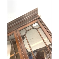 Late Victorian mahogany wall hanging corner cabinet, projecting cornice over blind fret work frieze, two astragal glazed doors enclosing shelf, pierced fret work brackets and apron, W52cm, H117cm