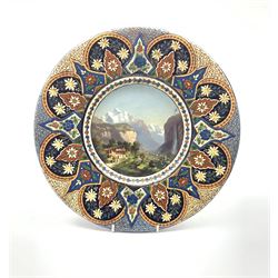 Thoune pottery charger, painted to the centre with a view of Brunnenthal by J. Stauffer, within incised foliate border, signed, D37.5cm 