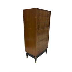 G-Plan - mid 20th century teak chest, fitted with seven drawers, brass loop handles, raised on an ebonised base 
