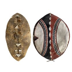 Zulu hide dance shield L91cm together with a Masai hide shield decorated in iron red, white and black (2)
