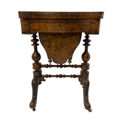 19th century figured walnut games table, the shaped fold-over swivel top revealing chess, backgammon and cribbage boards, frieze drawer over sliding shaped storage well, on twin turned pillars joined by double stretchers, foliate carved splayed supports on castors