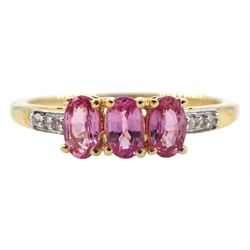 9ct gold three stone oval pink sapphire ring, with white zircon set shoulders, hallmarked, total sapphire weight 0.90 carat
