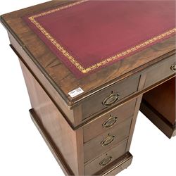 Late Victorian walnut twin pedestal desk, rectangular top with inset leather writing surface, fitted with nine graduating drawers, on castors