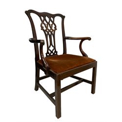 George III mahogany elbow chair, shaped cresting rail over Gothic Chippendale design splat with pierced decoration, shaped arms with scroll carved terminals, upholstered drop-in seat, square supports with inner chamfer united by plain H stretchers 