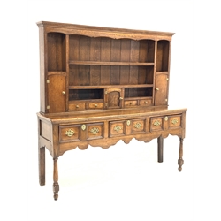George III oak dresser, dentil cornice over open shelves and cupboards, three drawers under, raised on turned front supports,  W190cm, H187cm, D52cm