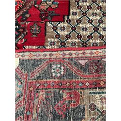 Persian rug with one central red medallion on beige field with geometric borders