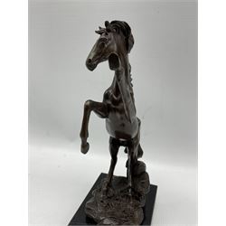 Bronze figure, modelled as a rearing horse, upon a rectangular black marble base, overall H26.5cm