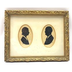 Harry Laurence Oakley (1882-1960) Pair of half length oval silhouette male and female portraits, each signed, 13cm x 8cm, framed as one 