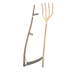 Late 19th/ Early 20th century four pronged elm hay fork, (H144cm) and a two handled scythe 
