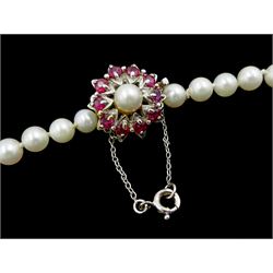Single strand graduating cultured pearl necklace, with white gold clasp set with rubies, stamped 9ct