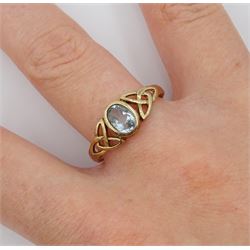 9ct gold oval blue topaz ring, with pierced Celtic knot design shoulders, hallmarked 