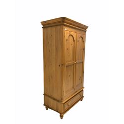 Pine double wardrobe, door enclosing interior fitted for hanging and with shelf, single drawer to base W109cm