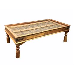 Indian hardwood coffee table, the top fashioned from a brass and metal bound door, raised on turned supports 141cm x 80cm, H47cm