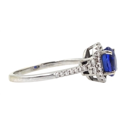 18ct white gold oval sapphire and diamond halo ring, with diamond set shoulders, stamped 750