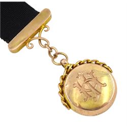 9ct gold compass, the reverse monogrammed 'JH', hallmarked on black ribbon with 9ct gold buckle and finials and clip 