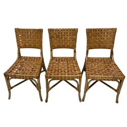 After John McGuire (American 1920-2013) - set of six 20th century bamboo and leather dining chairs, woven tan leather back and seat, on splayed supports united by X-stretcher