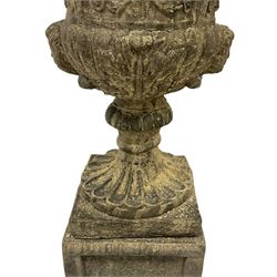 Pair of Georgian design ornate campana shape urns, egg and dart rim over scrolling rosette body with twin masks to the gadrooned underbelly, on square pedestal bases