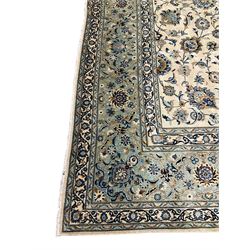 Persian Kashan carpet, ivory ground field decorated with interlacing foliate and stylised plant motifs, scrolling border with repeating flower head motifs, with signature panel