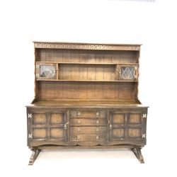 20th century oak dresser, the two height plate rack with lead glazed doors, three drawers and two cupboards to base, W165cm