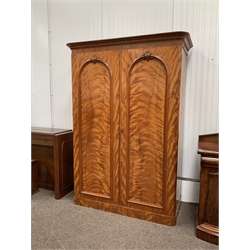  Victorian mahogany double wardrobe, with two arched panelled doors enclosing interior fitted with hooks, four slides and four drawers, W156cm, H216cm, D62cm  
