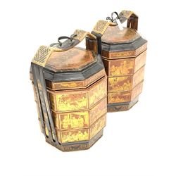Pair of Chinese lacquered octagonal food or noodle carriers, with three tiers, carry handle and decorated with oriental scenes and motifs H67cm