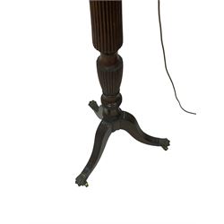 20th century standard lamp, with one turned and reeded column leading into three splayed supports, terminating in brass hairy paw castors 