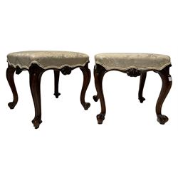 Pair 19th century carved walnut dressing stools, the square seat upholstered in floral cream fabric above a shaped apron with central scroll carving, raised on moulded cabriole supports terminating in scrolled feet