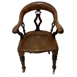 Victorian mahogany desk chair, bow-back over lozenge pierced splats and shaped saddle seat, raised on turned supports terminating to ceramic castors
