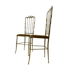 Pair gilt metal chiavari style chairs, after a design by Giuseppe Gaetano Descalzi, high back with shaped cresting rail over turned spindles, upholstered seat with turned front supports joined by stretchers 