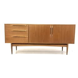 McIntosh & Co Ltd - Mid 20th century teak sideboard, fitted with double cupboard enclosing shelves, flanked by three graduated drawers, raised on tapering supports 