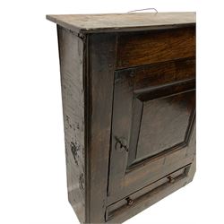 18th century oak wall hanging cupboard, enclosed by single fielded panel door, the interior fitted with seven small drawers, single drawer below