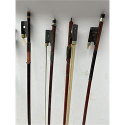 Nine various violin bows
