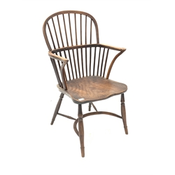 19th century yew and elm Windsor armchair, with hoop and spindle back, curved arm terminals, shaped saddle seat, raised on crinoline stretcher and turned supports