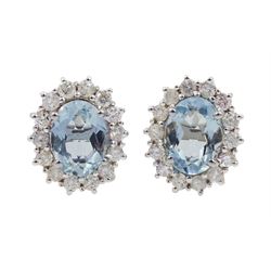 Pair of 18ct white gold oval aquamarine and diamond cluster stud earrings, hallmarked 