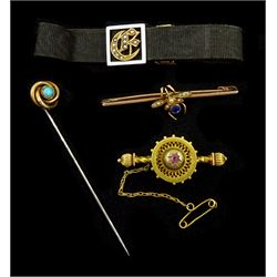 Victorian gold seed pearl and blue stone set insect brooch, 9ct gold Etruscan revival ruby bar brooch, Birmingham 1889, gold turquoise stick pin and a gold seed pearl and enamel 'E' initial memorial band on black miore strap