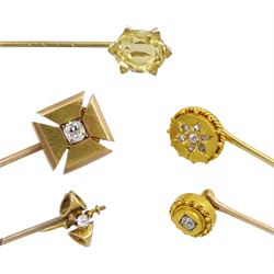 Four Victorian gold diamond stick pins including flower cluster and single stone cross of approx 0.15 carat and a gilt citrine pin