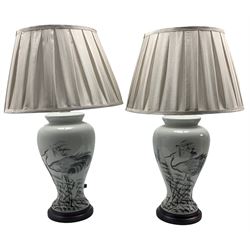 Pair of Chinese table lamps, each of baluster form painted with Herons amongst grasses, raised upon circular hardwood base, including shade H66cm